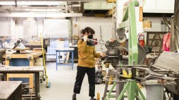 Student using press in sculpture shop