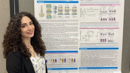 Image of senior mechanical engineer Angelica Baburova in front of poster.