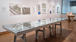 Gallery installation image with drawings and a model