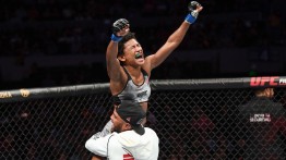 Angela Hill celebrates with cornerman Wilson Reis after TKO win vs Ariane Carnelossi in 2019