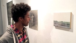 A visitor to The Cooper Union Staff Show admires a painting by Anna Hostvedt