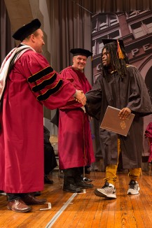Nils Anderson A'94, of the board of trustees, congratulates Sedrick Chisom A'16