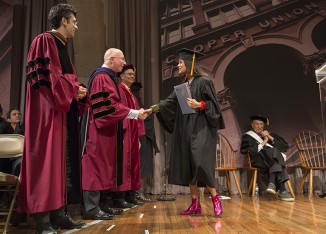 Arpana Rayamjhi A'15, receives congratulations from Richard Lincer, chairman of the board of trustees